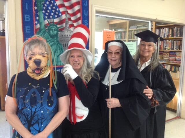 Food & Friends volunteer Ruth, Thrift Store Manager Debbie, President Suzi and store volunteer Jeannette showing off their fun costumes.